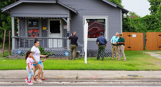 Investigators work near the Houston location of a fatal ICE shooting July 7. (Photo by Jon Shapley/The Texas Tribune)