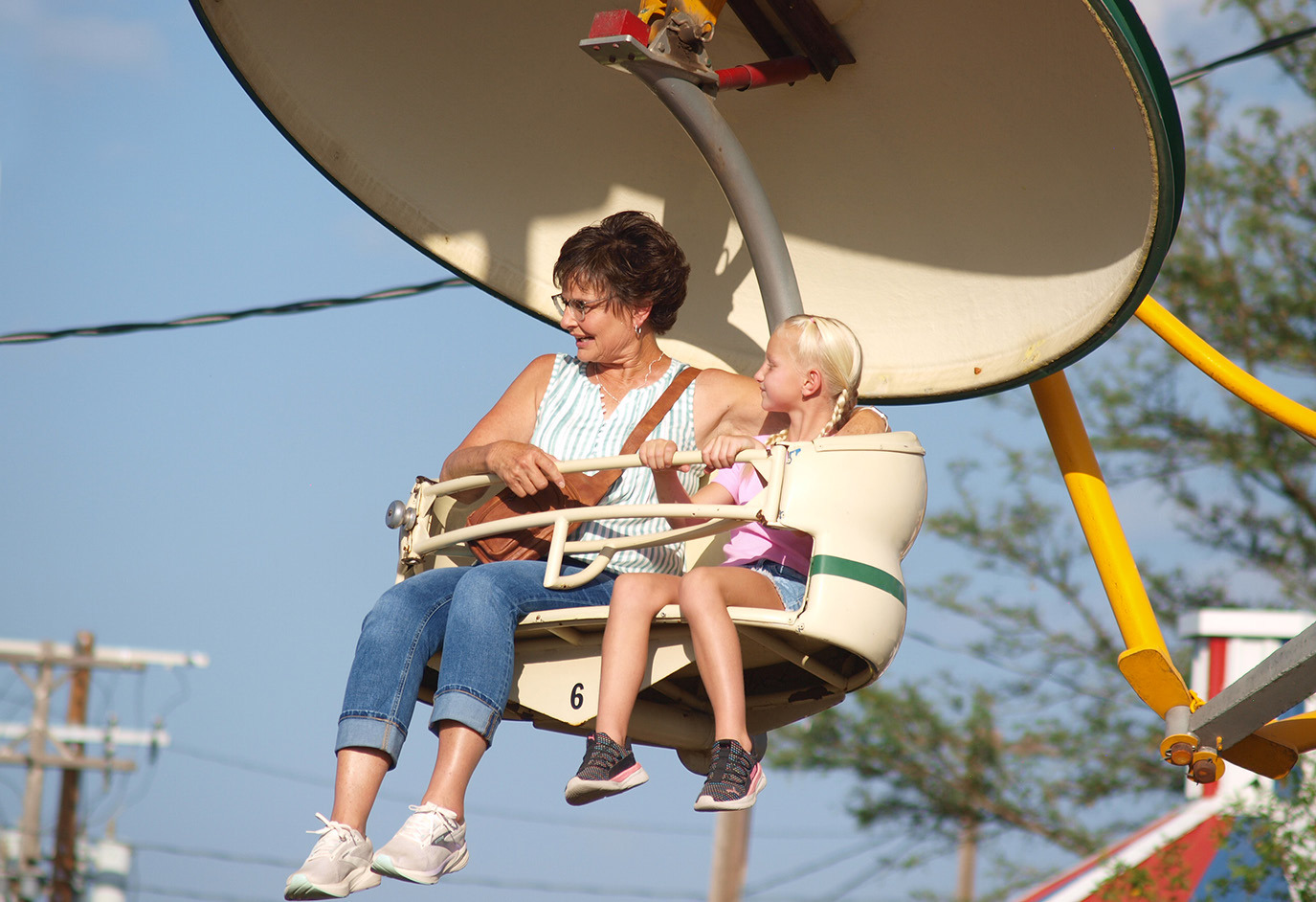 Two young ladies take in the sights while high above the crowds riding The Paratrooper.