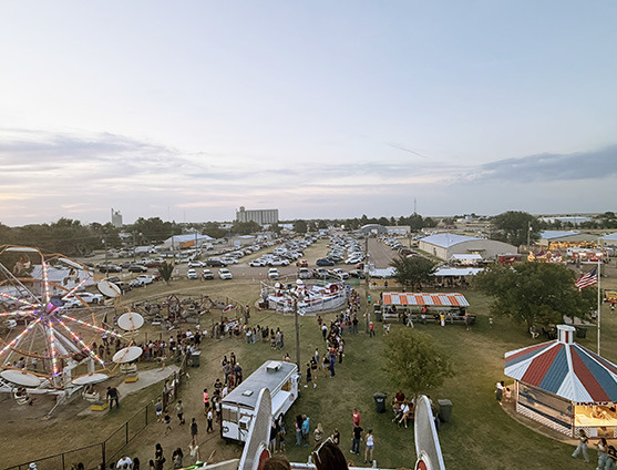A view from the top of the Ferris Wheel on Opening Night. (Sure are a lot of white vehicles out there!) Photo by Adriana Evans, Tribune, who came over to enjoy the Carnival.