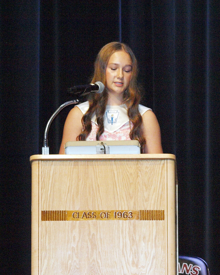 NHS Chapter President Tessa Bauck gives introductory remarks.