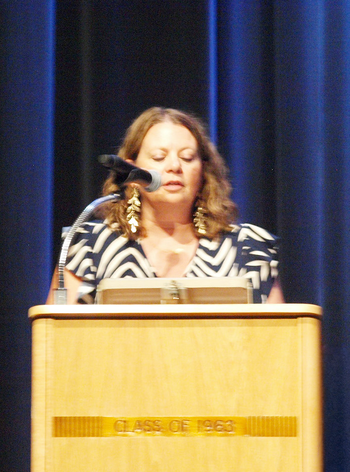 Mrs. Sara Brown delivers congratulatory remarks for the new members.