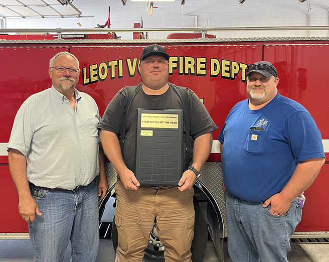Leoti Volunteer Fire Department’s first Firefighter of the Year, Brian Downing, center, poses with Fire Chief Mike Nickelson and Asst. Fire Chief Steve Baum.