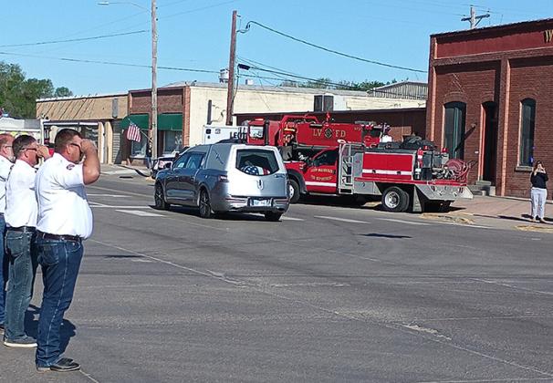 Bottom Left: The long procession enters downtown. Bottom Right: Firefighters salute the hearse carrying Firefighter Evans home.