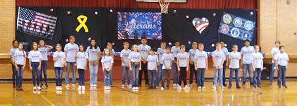 Wichita County Elementary School students paid tribute to Wichita County veterans in story and song. We apologize for the dearth of photos. Apparently the camera was confused by the lighting.