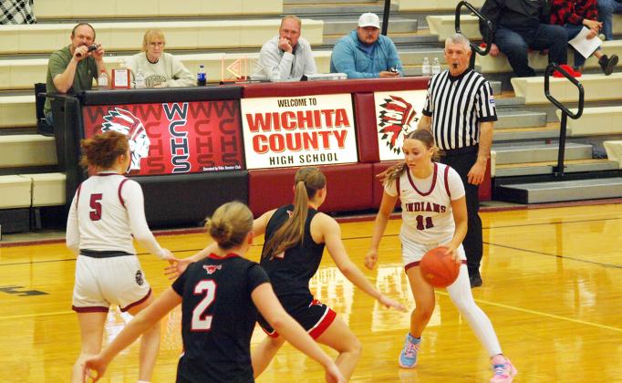 Audrina Marcy, 11, brings the ball to the defenders ad Katelyn Price, 5, prepares to assist.