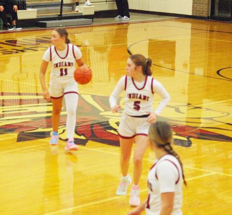The Lady Indians appear to check with the bench for strategy.