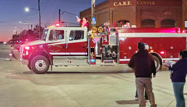 Above: Santa arrives in Leoti with a little help from the LVFD. Left: 'Let there be Christmas lights!' If he shouted it, I didn't hear, but he flipped the switch, so it's fair Christmas Cheer!