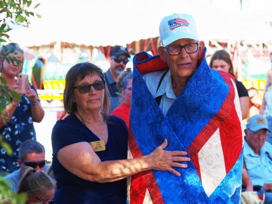 Julie Eddy helps wrap Keith Baker