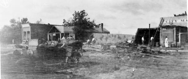 Above: This photograph, looking South on 4th street, is very difficult to make out. We believe the building at the far end to be the Leoti State Bank (current C.A.R.E. Center), with the City Market closest on the right.