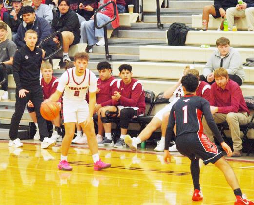 Dylan Luna, 0, determines his best way around the Mustangs defender as Coach Rietzke looks on.
