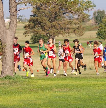 Above Left: WCJHS athlete Ruger Mazanec (278) starts the race towards the back. Left: Mazanec begins to move forward..