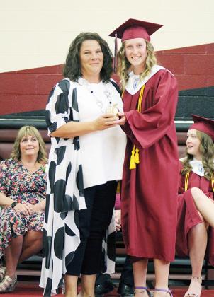 Below: NHS President Anna Simons presents the Golden Apple Award to Mrs. Janee Porter.