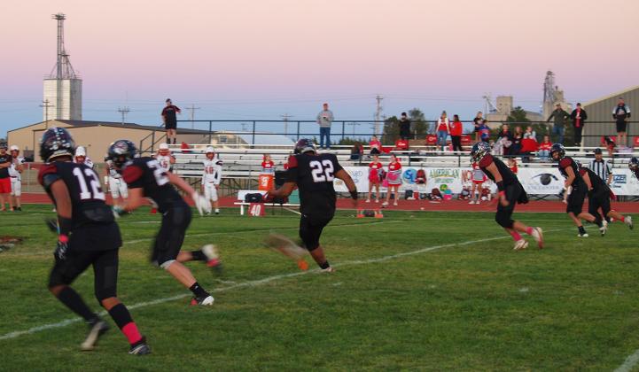 Gavvan Castillo (22) kicks to the Bulldogs after another Indians touchdown. In the foreground, David Romero (12) times his launch to the contact.