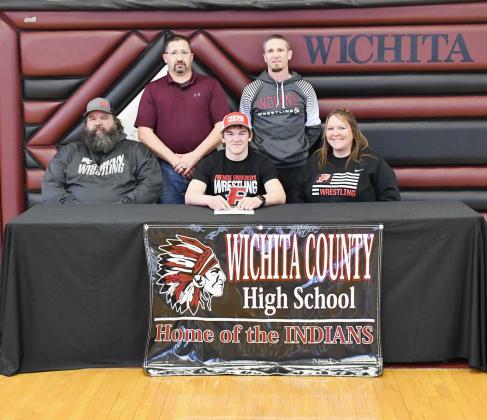WCHS Senior Wyatt Gardner, pictured here flanked by his parents Ben and Misty Gardner, has signed a letter of intent to wrestle at Friends University in Wichita, Kansas. Gardner is supported in the photo by coaches Brent Porter and Wesley Cooper. Photo courtesy Misty Gardner