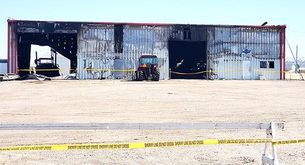 Sheriff’s Office Do Not Cross tape cordons off the Front (West side) of the Price Repair shop, which shows the scars of flames from the fire that destroyed the building on Sunday, March 17.
