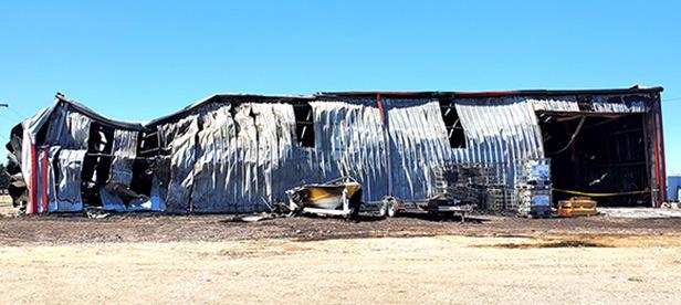 The walls on the East side of the Price Repair shop appear to have bent as the roof collapsed from an aggressive fire on March 17.