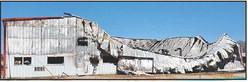 The South side of the Price Repair shop most graphically shows the destruction wrought by an intense fire that collapsed the roof, and buckled and collapsed walls.