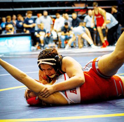 Continued as 'State Wrestling' on Page 9. Right: Jaelene Vestal—a firstyear wrestler(!)—competes at the State Tournament in Hays. Below:Tyson Peters, 126lb sophomore,wrestles his way into the heartbreak round.