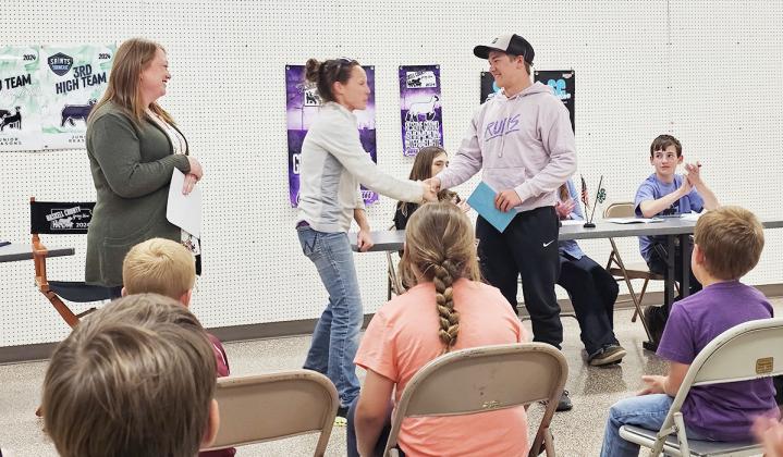 Lydia Jayhawker leaders Kyla Larson and Lora Imler congratulating their club senior, Wyatt Gardner, on his upcoming graduation.