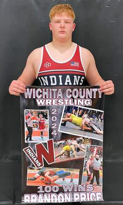 Brandon Price holds a poster celebrating his milestone 100th career wrestling win.