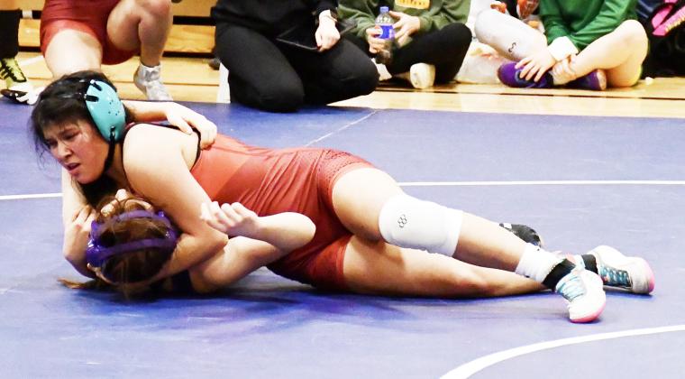 Above: Angela Barrera at Scott City. Photo by Beau Porter Below: Scott City Champions: Wyatt Gardner, Jentri Porter, and Brandon Price. Photo by Heather Price