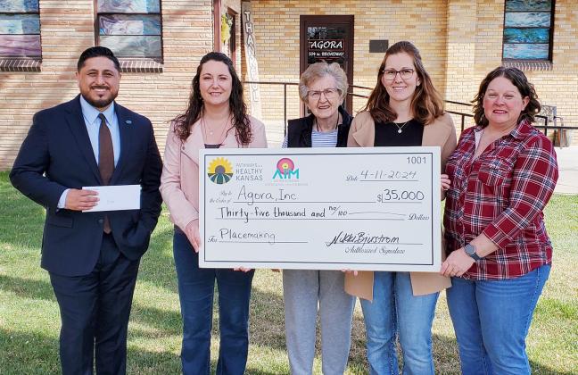 Blue Cross Blue Shield Kansas representative Miguel Rosales, Wichita County Economic Development Director Nikki Bjurstrom, and AIM Coalition’s Tammy Simons, flank Agora, Inc., board member Margaret Pritchard and board chair Simone Elder as they present Pathways to a Healthy Kansas grant funds.