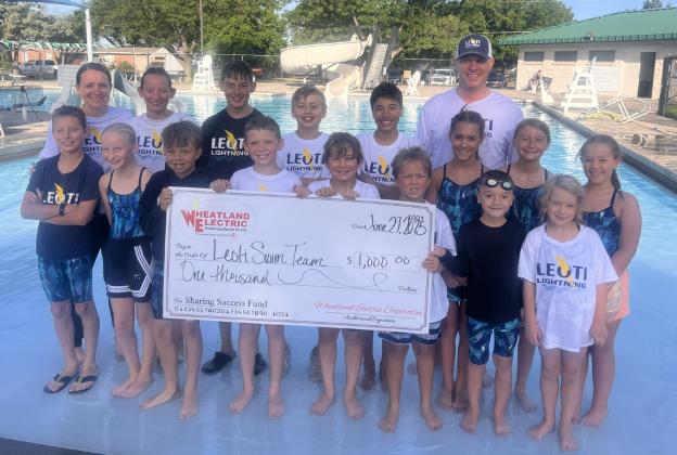 The Leoti Lightning Swim Team with coaches Jenny Long (left) and Matt Long (right) were awarded a $1,000 Wheatland Electric Sharing Success grant to help fund new starting blocks and lane line repairs.