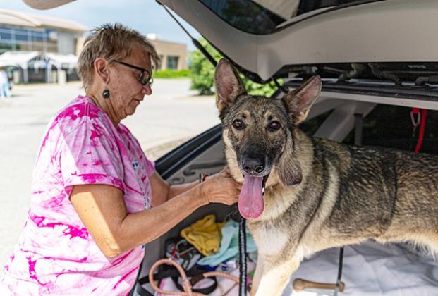 Linda Ruzich and a dog from the Kansas Humane Society prepare for a drive to Topeka for a specialist vet visit. Zachary Ruth/KMUW