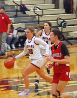 Senior Emma Berning drives down the court.