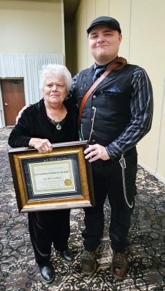 Kelma Burch holds the ornately framed award for Outstanding Member of the Year, presented to her at the state Rural Letter Carriers' Association state convention in Wichita. Beside her stands her event escort, grandson Weston. Photos provided.