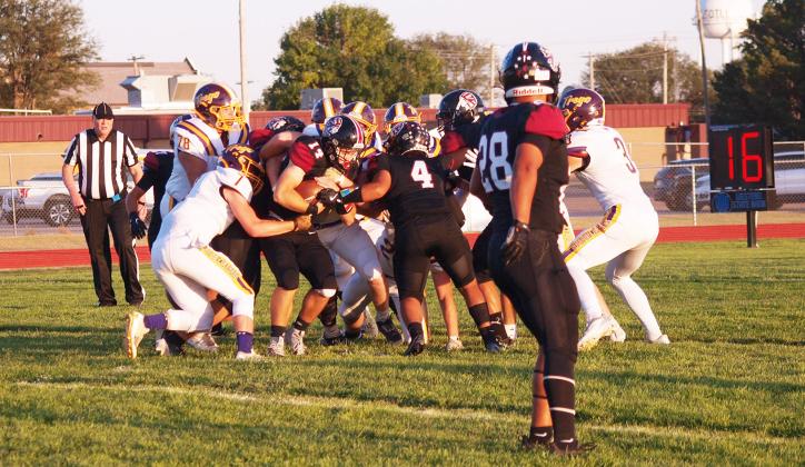 Young (14), carrying the ball, is swarmed by friend and foe alike, including Pablo Reyes (4). In the foreground, Hermosillo (28) looks on.