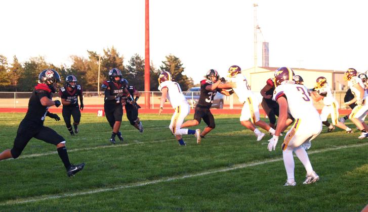 Fourth Indians player from the left, Young (14), partially hidden by Reyes (4), has the ball deep in his own territory. Also in the photo, Dylan Luna (7), Hermosillo (28), and Whitham (33).