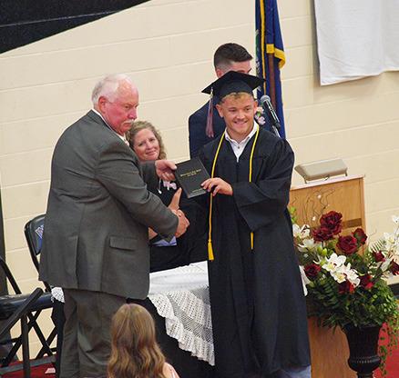 Cashton Young accepts his diploma from BoE member Farrin Watt