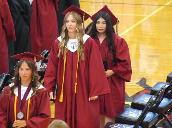 Salutatorian Jentri Porter, Audrina Marcy, and Alexa Mancillas reflect as they wait to leave