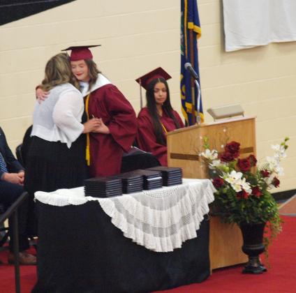 Class President Katelyn Thurman presents Mrs. Melanie Staab with the Golden Apple Award.