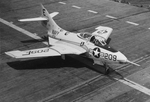 Above: An F9F-8 Cougar aboard the USS Intrepid in April, 1956. (Wikimedia