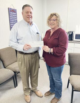 John Pinegar of the KS Legislative Policy Group presents a check to Diana Long, Wichita County Treasurer. (provided)
