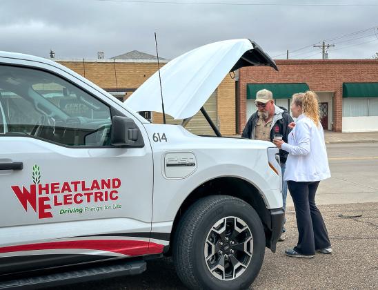 Mary Hoisington, member services and key accounts manager at Wheatland Electric, discusses the key benefits of the all-electric Ford F-150 Lightning with attendees during the EVs &amp;amp; Espressos event in Leoti on Oct. 8, 2025. Photos courtesy Wheatland Electric