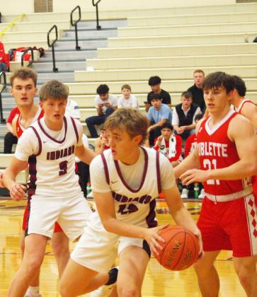 Above: Dylan Luna looks for someone an open teammate during the homecoming game Jan 27. Leoti boys lost to Sublette 51-60. Below: Grayson Owens (3) and Chase Carpenter (13).