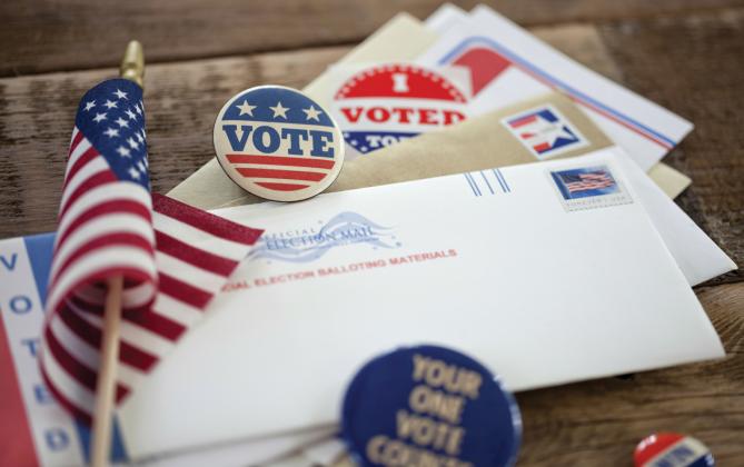 Postal chief insists to Congress that mail-in ballots will get delivered in time