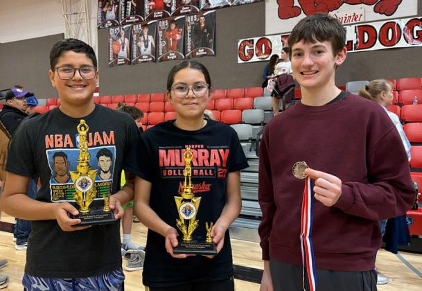 Bryan Michel, Brianna Michel, and Zachary Marcy showing the hardware they earned at the Knights of Columbus Free Throw Contest.