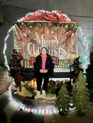 Kelma Burch gets her picture taken in The Native Sun's 'Snow Globe' photo area. Weather permitting, the stage will be available through December.