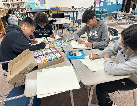 Right: Ayden Me n d e z , Efren Lemus, Jerman Lira, Juliana Osuna using markers and poster board purchased with WCCF gran t fo r Reading Intervention activity. Provided