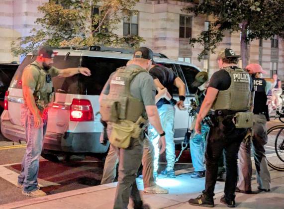U.S. Marshals and Homeland Security Investigations agents take a man into custody on Sept. 3, 2025, at the intersection of 14th and N streets NW in Washington, D.C. (Ashley Murray/States Newsroom)