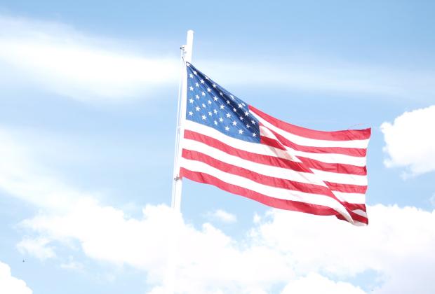 Old Glory, raised by the Free in honor of the Brave, presides over the Wichita County Fair Carnival.