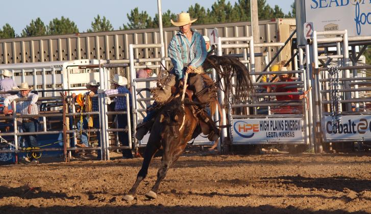 An unidentified cowboy participates in the saddle bronc competition at the Fair rodeo.