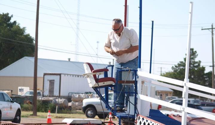 Mike Nickelson prepares to take the operator's seat for the Tilt-a-Whirl on Opening Day of the Carnival for the Wichita County Fair. Everybody loves the train!