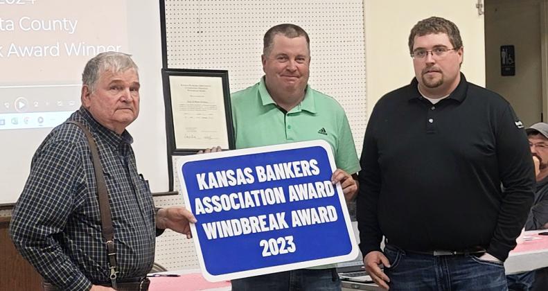 Tony Harkness and Brian Harkness of Harkness Repair, LLC, are presented with the Kansas Bankers Association Award 2023 Windbreak Award at the 76th Annual Meeting of the Wichita County Conservation District, held January 29, 2024, at the Community Building. Presenting the sign and plaque to the father/son duo is Tristan Perry of Security State Bank. Photo courtesy Darla Lewis