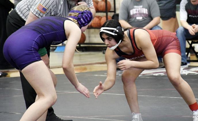 Above: Kimberly Perez shows her determination. Below: Tayson Guerra wrestles his way to 4th place.