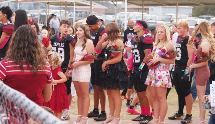 Members of the Homecoming Court line up to take the field for the crowning ceremony.